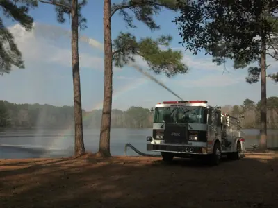 fire truck spraying water into a lake